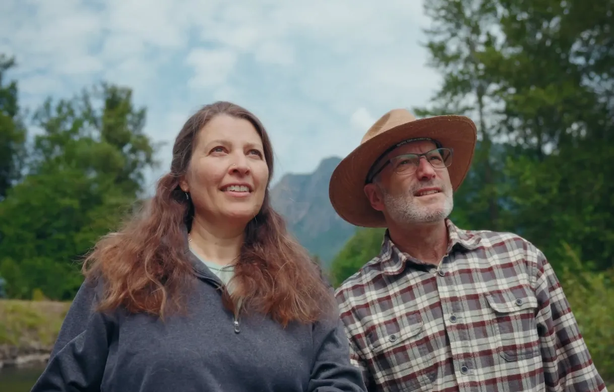 Two people outdoors by a river, from an enterprise testimonial shoot