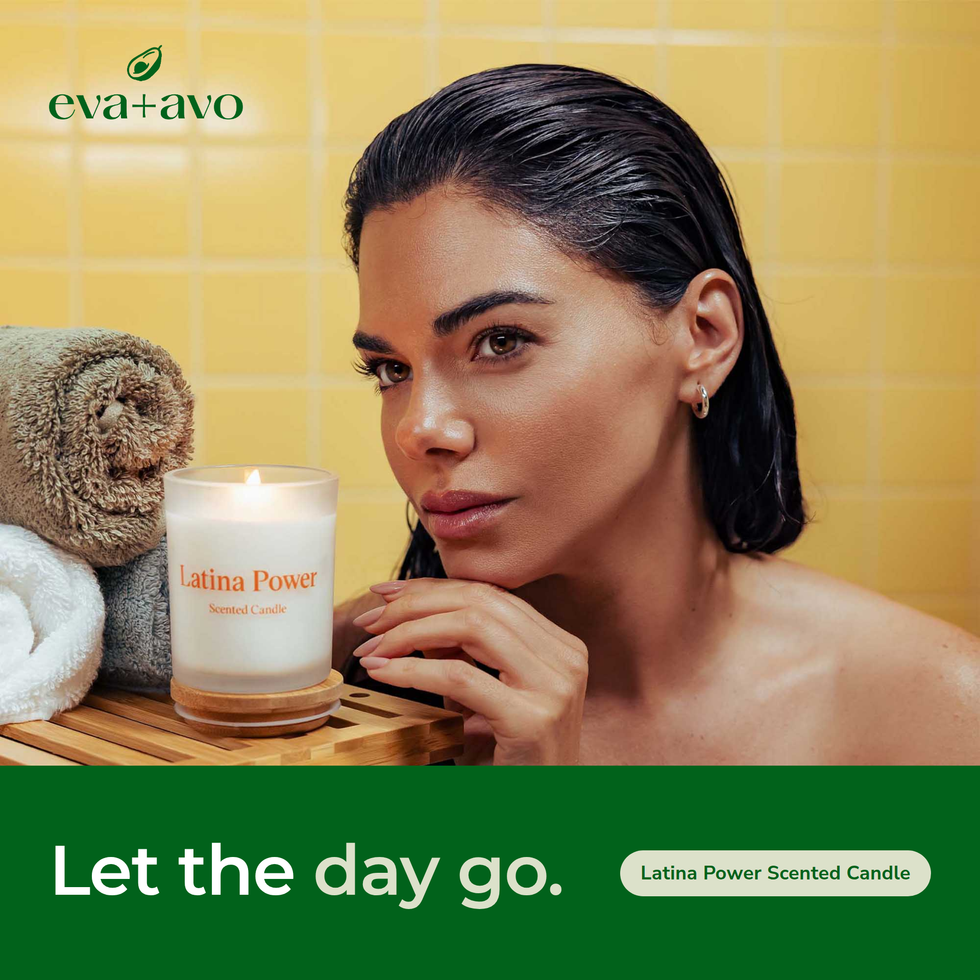 Woman rests her chin on her hand beside a lit Latina Power scented candle and rolled towels against a yellow tiled wall, above a green band reading Let the day go.